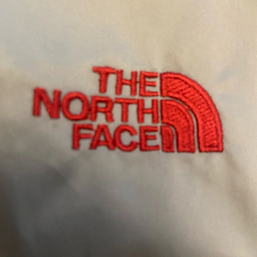 The North Face Men's Gray Windbreaker with Red Accents Size M.